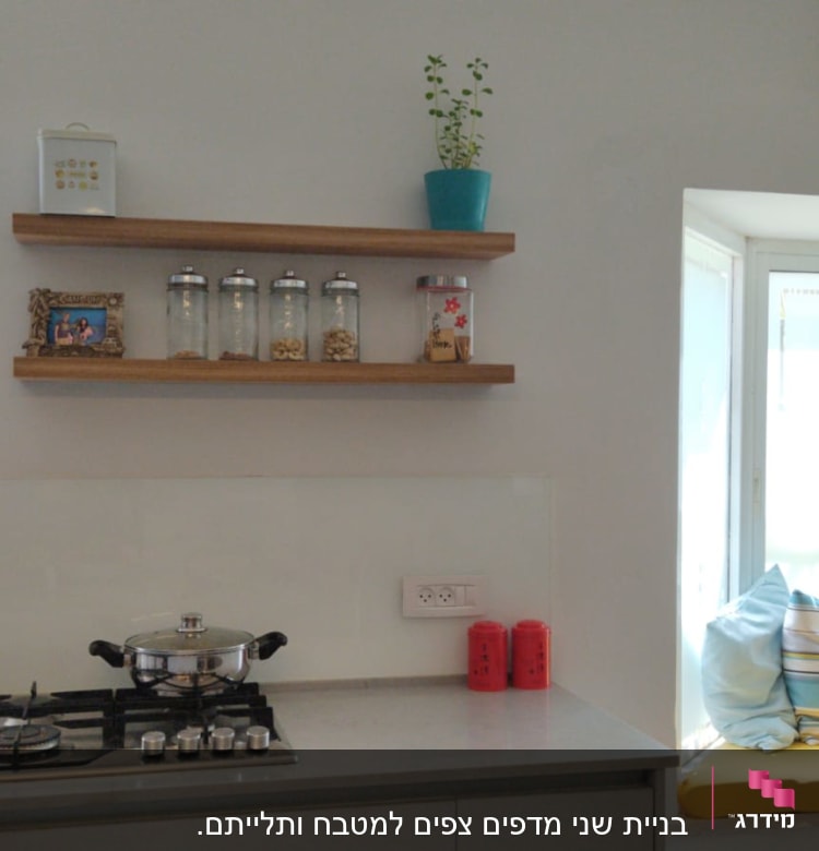 מדף עץ עם צנצנות תבלינים במטבח